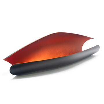 An open tube with a higher side on the back. The outside is black and the inside is orange.