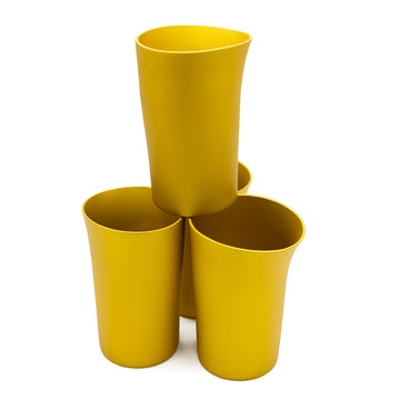 Four gold beakers are stacked up with one beaker on top of the other three. The beakers have a asymmetrical shape.