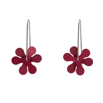A pair of drop earrings in the shape of red propellers.