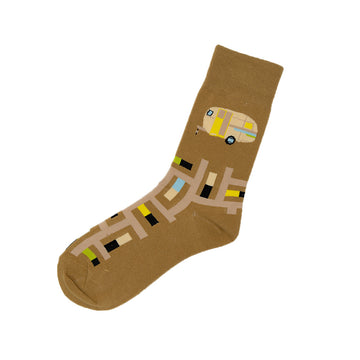 A sock is laying flat featuring an illustration of a caravan on a brown background.