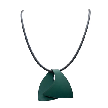 A pendant made from anodized green stainless steel in the shape of a folded over wave on a black cord.