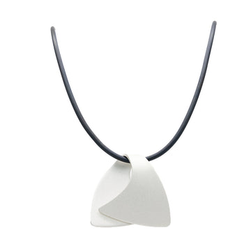 A pendant made from anodized silver stainless steel in the shape of a folded over wave on a black cord.