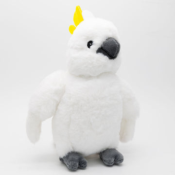 A white cockatoo soft toy is standing up against a light grey background.