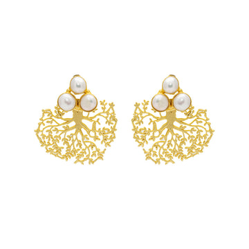A pair of statement earrings in gold in the shape of an upside down tree with three white pearls at the top in a triangle shape.