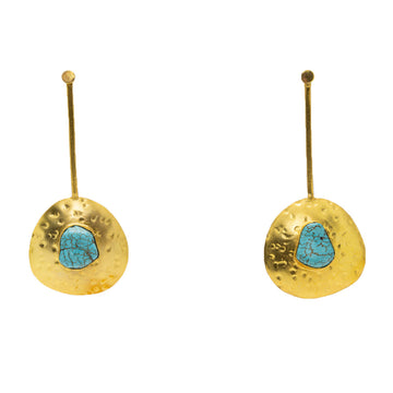 A pair of drop earrings in gold with a irregular shaped circle at the bottom and a turquoise stone in the middle.