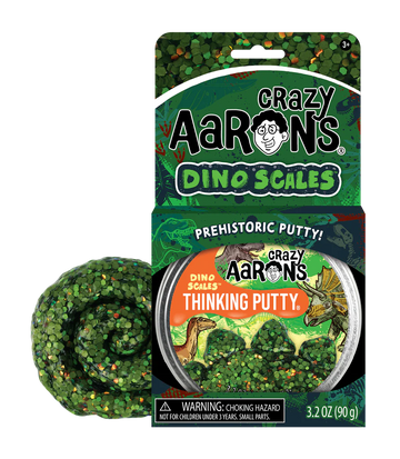 A round silver container with the title 'Crazy Aaron's Dino Scales Thinking Putty' with illustrations of dinosaurs and trees.