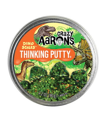 A round silver container with the title 'Crazy Aaron's Dino Scales Thinking Putty' with illustrations of dinosaurs and trees.