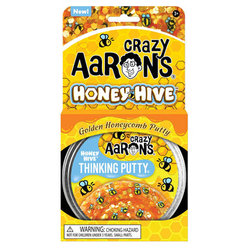 A round silver container with the title 'Crazy Aaron's Honey Hive Thinking Putty' with illustrations of bees and honey.