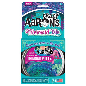 A silver round container titled 'Crazy Aaron's Mermaid Tail Thinking Putty' inside a cardboard sleeve.