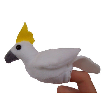 A plush cockatoo finger puppet on a finger against a white background.