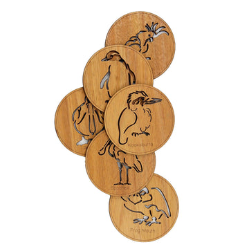A set of six round coasters made from wood featuring the outline of a different animal laser cut on each of them. The coasters are laid out with some overlapping.