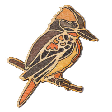 A wooden Australian kookaburra bird brooch. The Kookaburra is sitting side on, on a branch that makes up part of the brooch.  