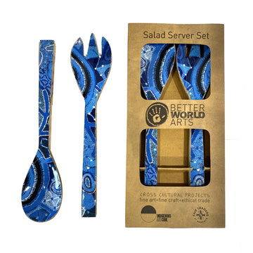 A salad server set of utensils featuring blue artwork by Theo Hudson. The salad servers are pictured both outside and inside their box.