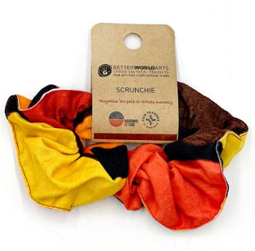 fabric scunchie featuring orange red yellow and brown shapes