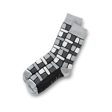 Grey socks pictured with a block print in shades of grey and white.