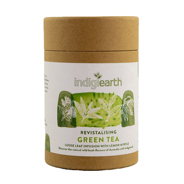 A cardboard container with a white product label and the text 'Indigiearth Revitalising Green Tea' visible.
