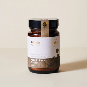 Amber coloured glass jar, black plastic lid, label with indigenous motif. Kakadu Plum Co, Australian Sustainable, Kakadu Plum powder, type printed on label. Logo printed on tamper proof tab.