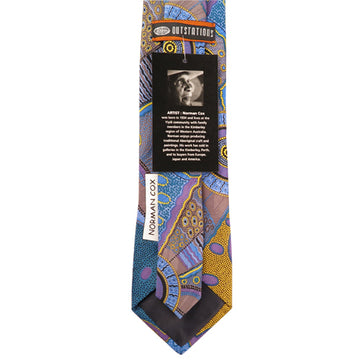 A tie featuring artwork by Norman Cox in blue, purple and yellow.