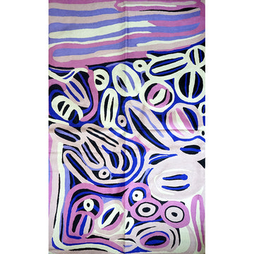 Rug featuring artwork by Anmanari Brown. The rug design has purple and white circles and lines on a blue background.