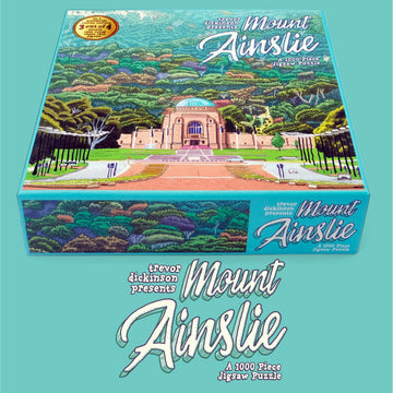 Mount Ainslie puzzle box featuring an illustrated image of the War Memorial with lots of trees on Mount Ainslie in the background.