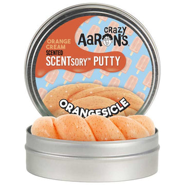 A silver round container with the text 'Crazy Aaron's Scented Scentsory Putty Orangesicle' with images of orange icecreams . There is a second container in front showing the orange putty inside.