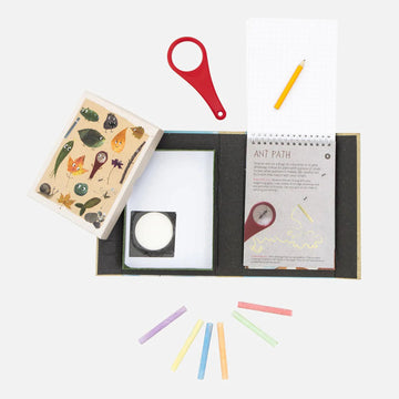 Outdoor Activity set box cover showing illustrations of bugs and leaves with a cut out showing a magnifying glass inside.