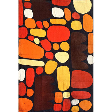 A tea towel is lying flat featuring artwork of abstract circular shapes in reds and brown by Keturah Nangala Zimran.