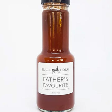A clear bottle with a black lid and white product label. The label says 'Black Horse Father's Favourite' with an image of a horse. The sauce can be seen through the bottle.
