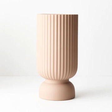 A round tall vase with a round base and embossed with vertical lines.