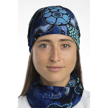 A tubular piece of fabric printed with illustrated turtles by Garry Purchase on a blue background.