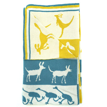 A blue, yellow and white baby blanket is folded up with the corner folded over to show the back.