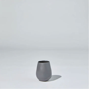 A round ceramic cup in grey.