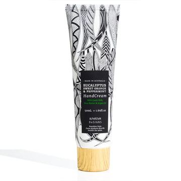 A small tube of hand cream featuring artwork by Mick Harding with a black product label and wood look lid.