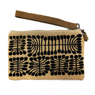 A small pouch in brown with black artwork printed on the front y Mitjili Narpurrula. The pouch also had a brown wrist strap and zip.