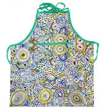 An apron is laid out flat featuring artwork in blue and yellow by Cedric Varcoe.