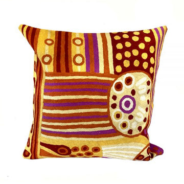 Woven woollen, zippered cushion cover 40cm x 40cm, stitched onto cotton base. Artwork by Julie Woods. Yellow, brown, red ochres; purple, white. Off centre circle with symbols; lines dots.