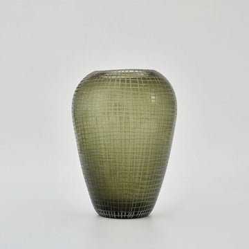 A tall vase with a rounded top and tapered base in moss green glass with a grid pattern.