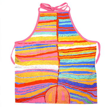 An apron is laid out flat featuring artwork in pink, yellow and blue by Judy Watson.