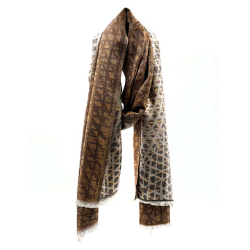 A scarf printed with artwork by Paulina Puruntatameri in brown is draped like its being worn around a neck.