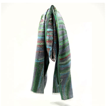 A scarf printed with artwork by Rama Sampson in green is draped like its being worn around a neck.