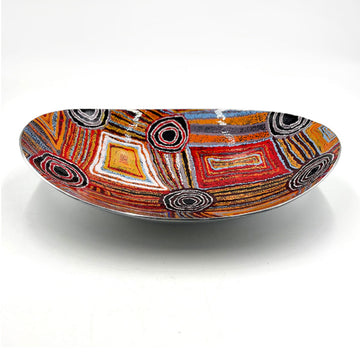 An long oval shaped bowl in stainless steel printed with artwork by Mary Napangardi Brown inside.