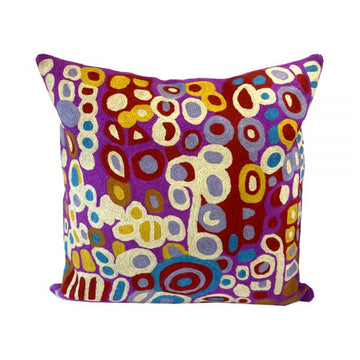 Woven woollen, zippered cushion cover 40cm x 40cm, stitched onto cotton base. Artwork by Anmanari Brown. White, red, purple, blue, yellow, circles and symbols. Red and purple background.