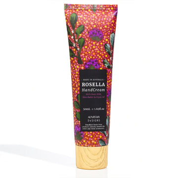 A tube of hand cream is pictured featuring artwork by Elizabeth Ngwarraye Bonney with a black product label with a wood look lid.