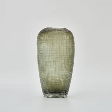 A tall vase with a rounded top and slightly tapered base in moss green glass with a grid pattern.