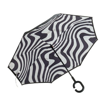  An open umbrella with a wavy black and white design with a black handle.