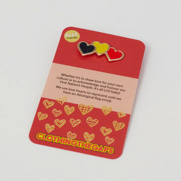 A pin made up of three hearts, one in black, one in yellow and one in red on a red product card.