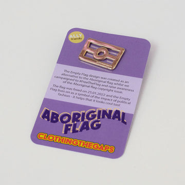 A gold pin in the shape of the Aboriginal flag on a purple product card.