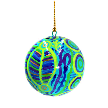 A Christmas bauble printed with artwork by Cedric Varcoe in blue and green.