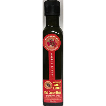 A tall glass bottle with a black lid and red product label. The label says 'Australian Wild Limes Red Cente Lime'.