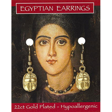A pair of gold drop earrings in the shape of a scarab on a backing card. The card has an illustration of a woman's head and the text 'Egyptian Earrings'.